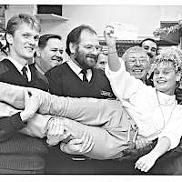 The shop donated money to Penn ambulance crews working without pay. The photograph shows (left to right) Sandra Taylor, Frank Roberts, Mick Bowen, Peter Lloyd, Jeff Barlow and Ron Smith, holding up Lisa Smith.